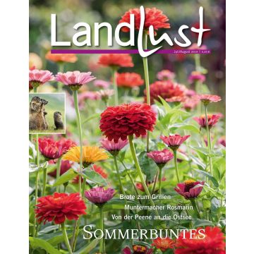 Zeitschriftencover „LandLust“ Juli/August 2019. Vordergrund mit bunten Zinnienblüten. Oben „LandLust“-Logo, rechts Themenübersicht. Linkes Bild zeigt Murmeltiere. Text: „Sommerbuntes“.